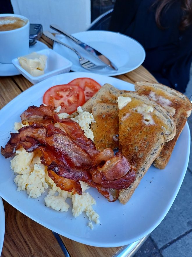 A full breakfast plate with coffee alongside