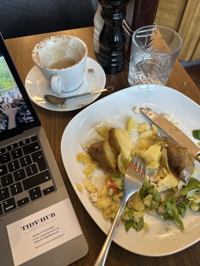 Scrambled egg and toast beside a coffee and a laptop, cropped clear of the burned-in words